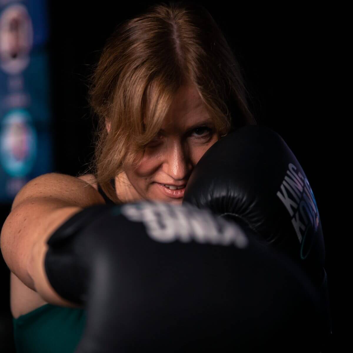Frau mit Boxhandschuhen im Boxtraining im King Kong Club Salzburg.